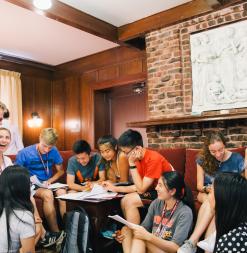 Stanford University Mathematics Camp participants gather in the common space in order to work together on some problems.
